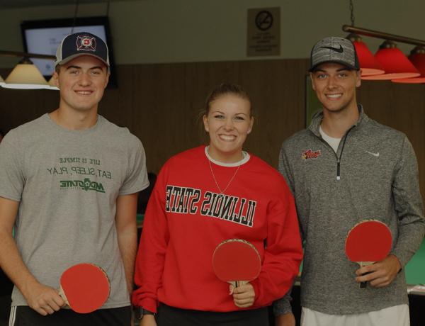 Siblings playing ping pong in the Bowling and Billiards center